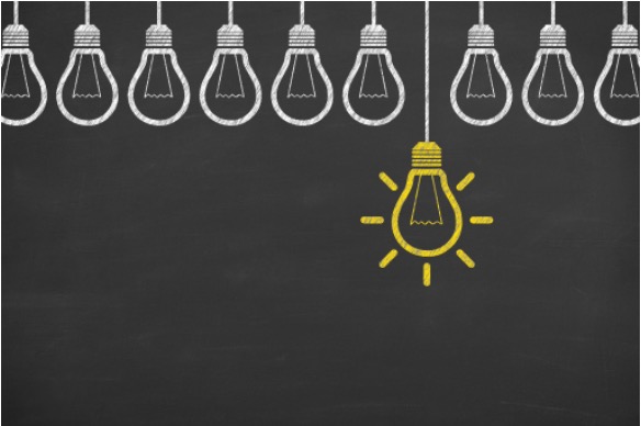 One yellow light bulb among a row of white bulbs